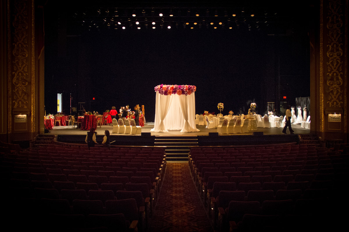 White ceremony canopy on stage, tables set up behind