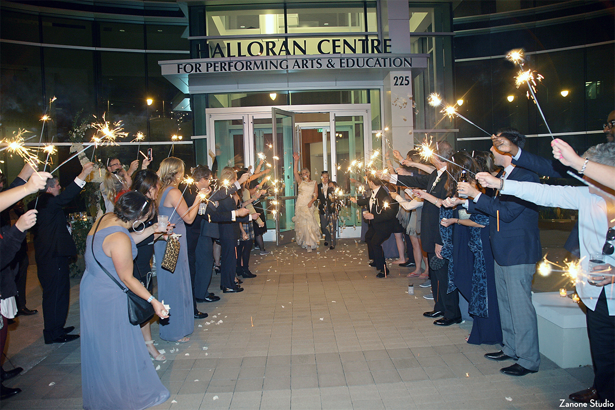 Wedding guests outside Halloran Centre with sparklers, sending off newlyweds